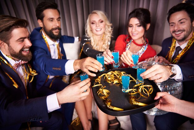 Бесплатное фото Группа друзей, пьющих синий кюрасао в ночном клубе