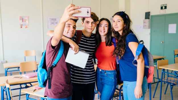 무료 사진 교실에서 selfie를 복용하는 친구의 그룹