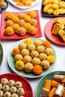 group of indian assorted sweets or mithai with diya