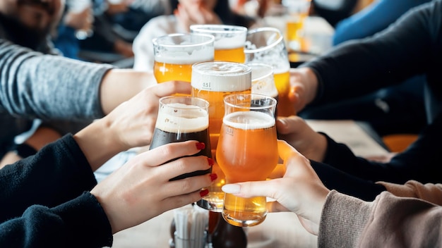 Free photo a group of people clinking glasses with beer