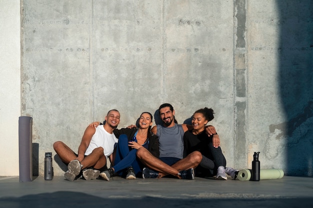 Free photo group of people exercising together outdoors