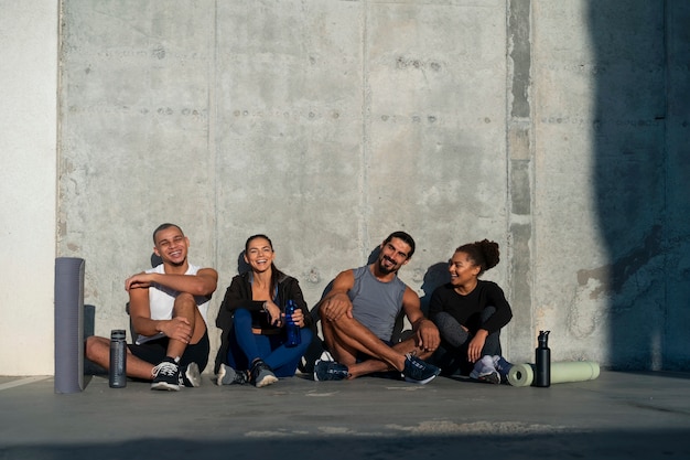 Free photo group of people exercising together outdoors