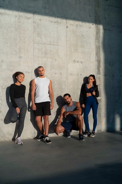 Free photo group of people exercising together outdoors