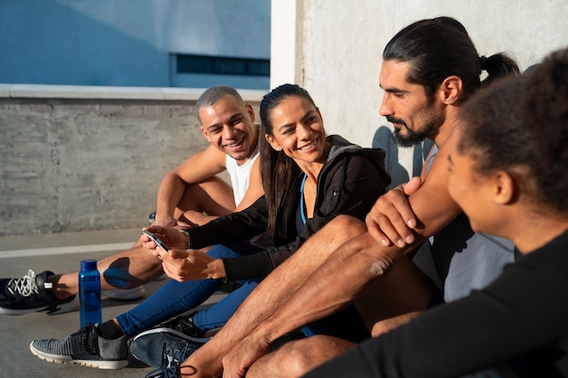 Free photo group of people exercising together outdoors