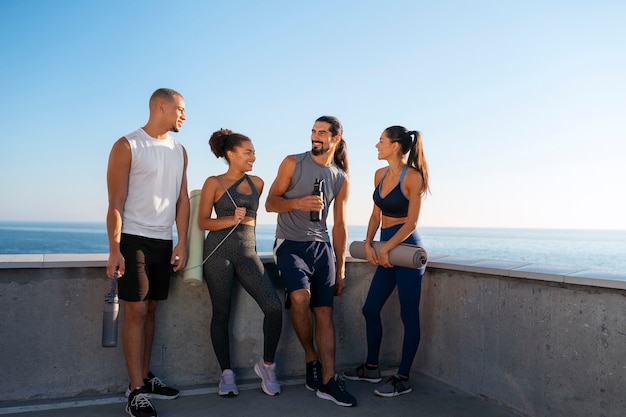 Free photo group of people exercising together outdoors