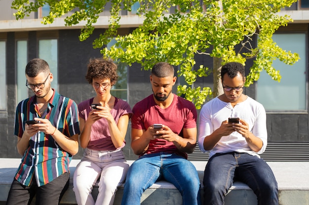 Gruppo di persone concentrato sui loro smartphone