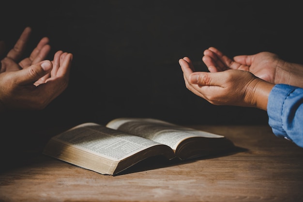 Group of people holding hands praying worship believe