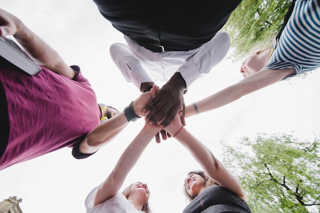 Group of people holding hands together