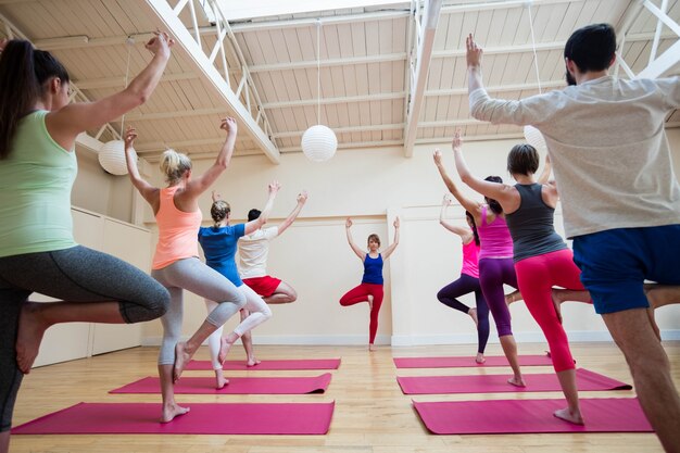 Group of people performing gyan mudra yoga exercise