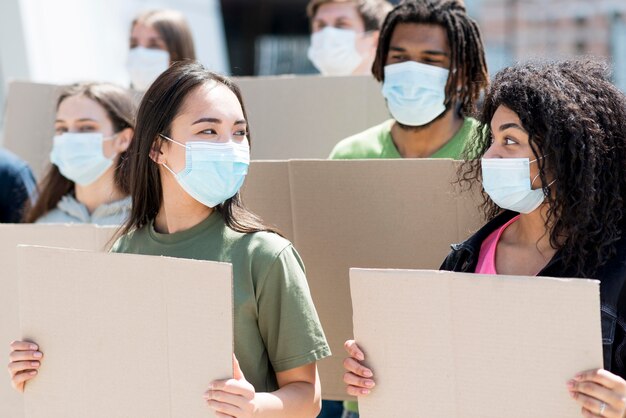 Group of people protesting and wearing medical masks