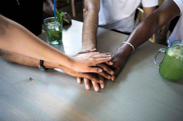 Group of people putting their hands together