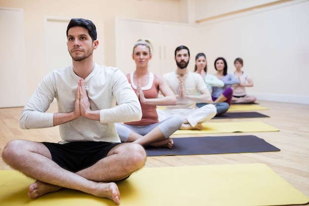 Group of people sitting in lotus position