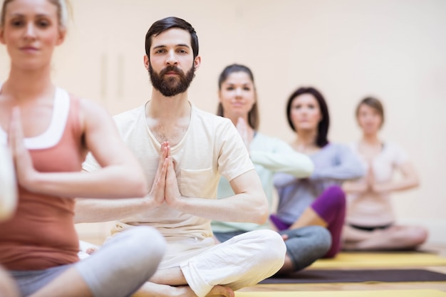 group of people sitting in lotus position
