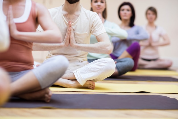 Free photo group of people sitting in lotus position