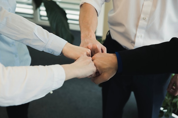 Group of people stacking hands