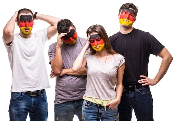 Group of people supporters fans of Germany national teams with painted flag face sad frustrated emotions. Fans emotions.