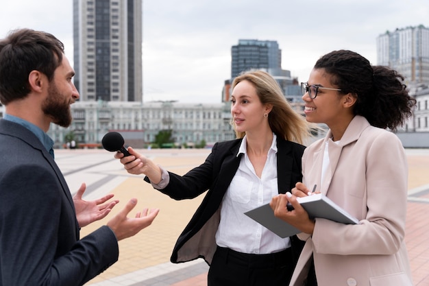group of people taking an interview for the news