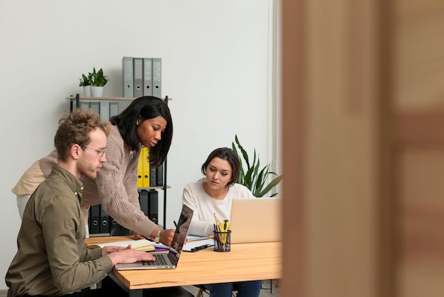 Group of people teaming up at work with copy space