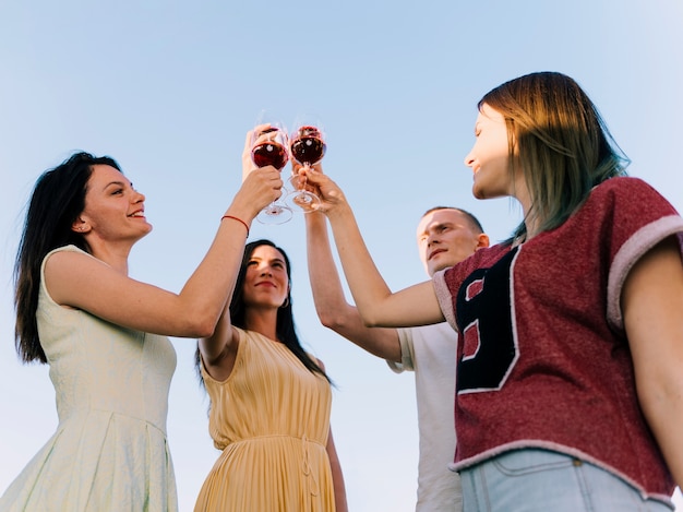 Group of people toasting in the sunlight