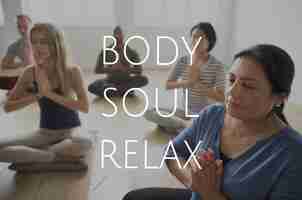 Free photo group of people training in yoga class for body soul and mind relief