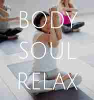 Free photo group of people training in yoga class for body soul and mind relief
