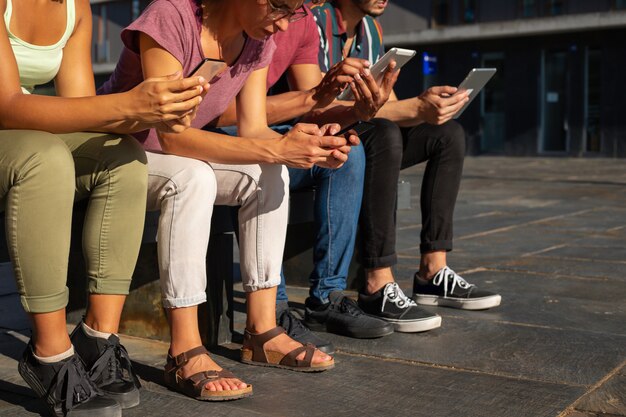 Group of people using gadgets outdoors