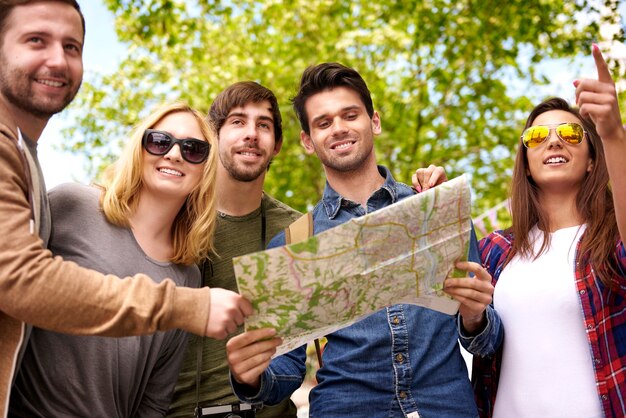 Group of people using a map to look a destination