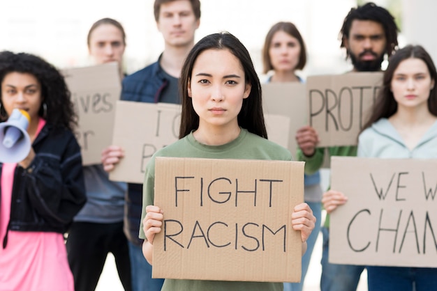 Group of people with fight racism quotes