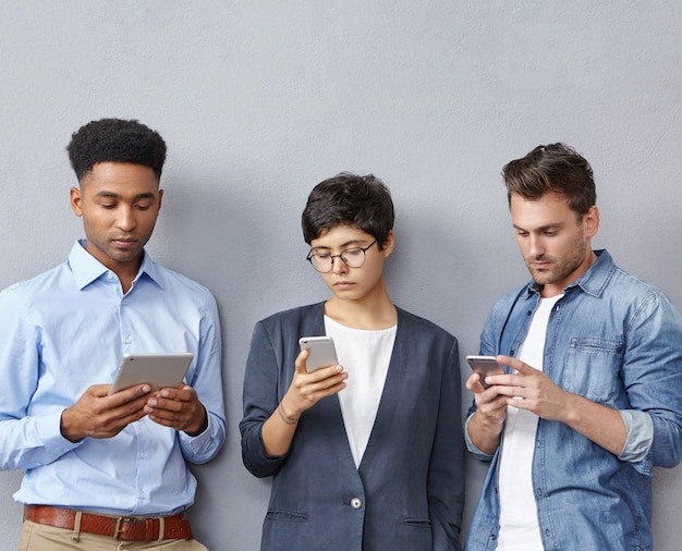 Group of people with smartphones and tablets