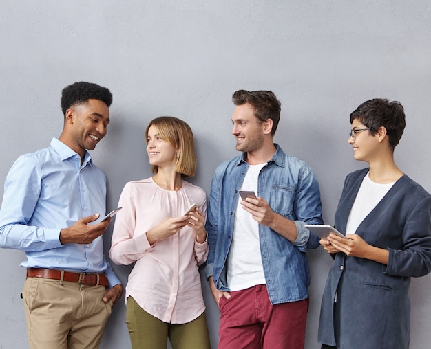 Group of people with smartphones and tablets