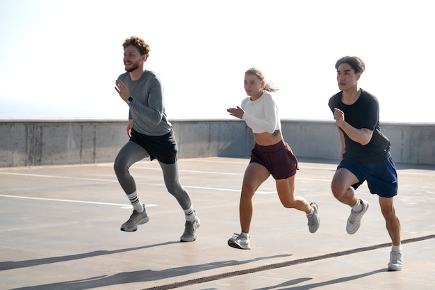 Free photo group of people working out together outdoors