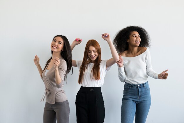 Group of positive young women cheering together