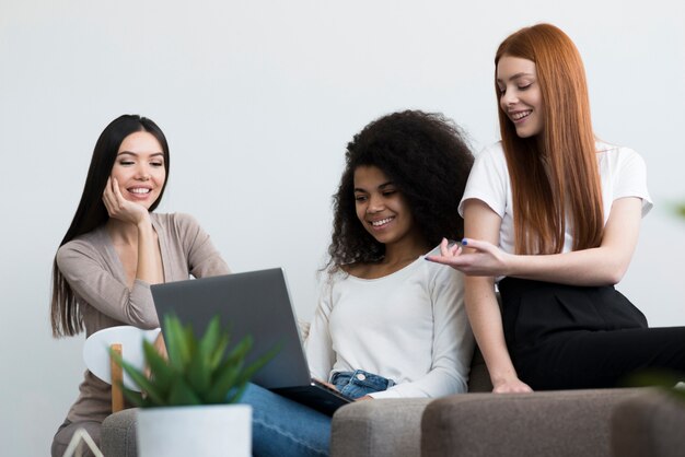 Group of positive young women working together