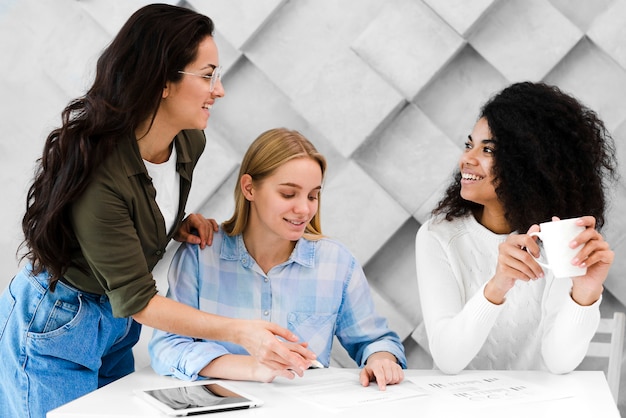 Group of positive young women working together