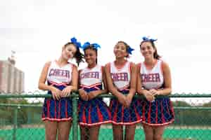 Free photo group of pretty teenager cheerleaders in cute uniform