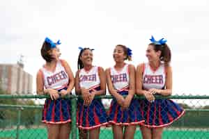 Free photo group of pretty teenager cheerleaders in cute uniform