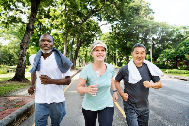 Free photo group of senior friends jogging together in a park
