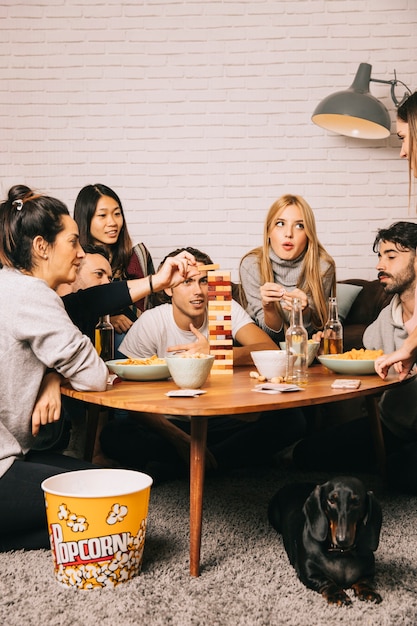 Group of six friends playing tabletop game