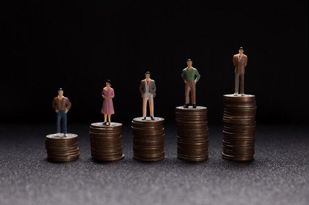 Group of small businessmen standing on coins