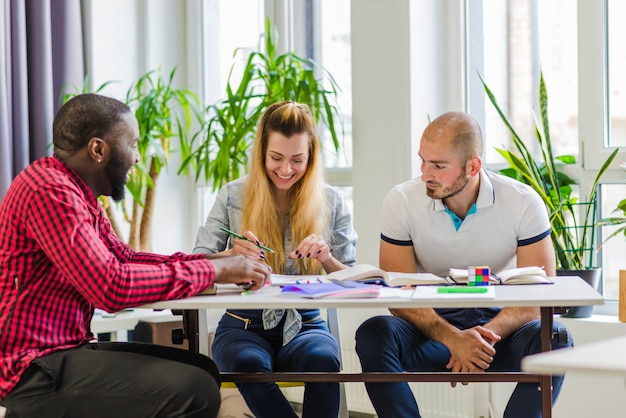 Group of smiling people working at table