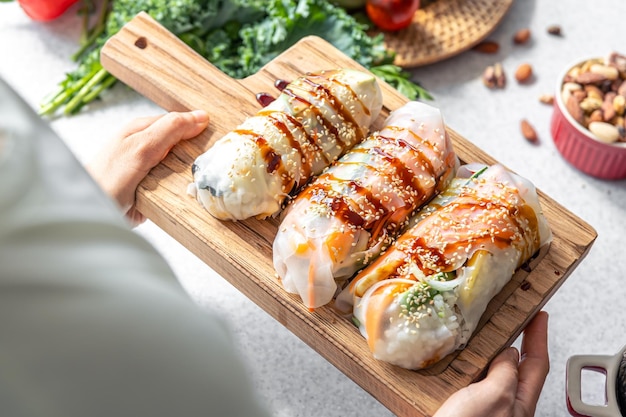 Get Beautiful Free Stock Photos of a Group of Spring Rolls with Rice Paper Filled with Vegetables
