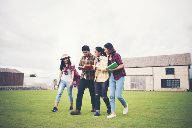 Group of student walking through the park after class. Enjoy talking together.