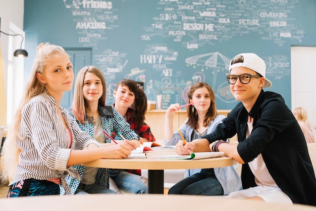 Free photo group of students posing at table