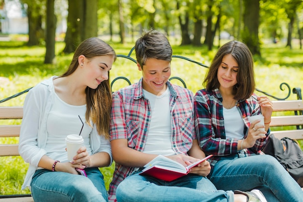 Group of students reading book together