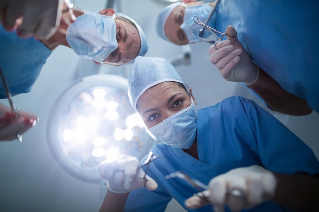 Group of surgeons performing operation in operation room