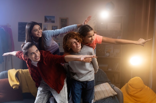 Group of teenage friends posing together at home during party