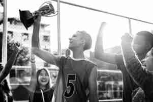 Free photo group of teenagers cheering with trophy victory and teamwork concept