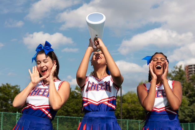 Free photo group of teenagers in cheerleader uniforms