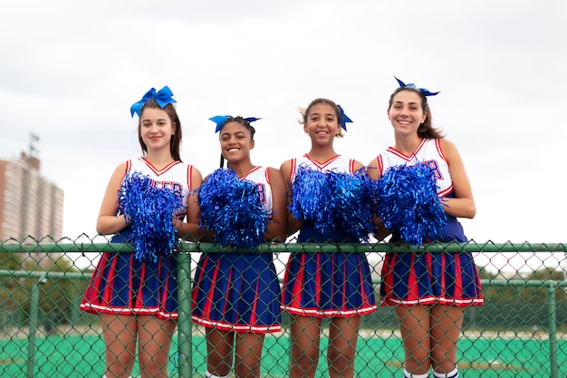 Free photo group of teenagers in cute cheerleader uniform