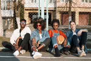 Free photo group of teenagers posing together outdoors